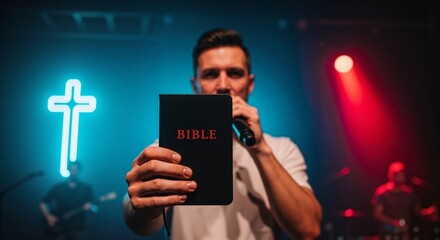 A pastor on stage holding a Bible and microphone during a modern church service. Christian worship concert with a neon cross and band in the background. Preaching the gospel concept