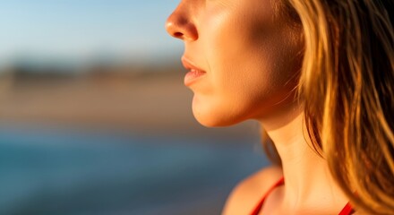 Woman enjoying summer beach vacation at sunset golden hour