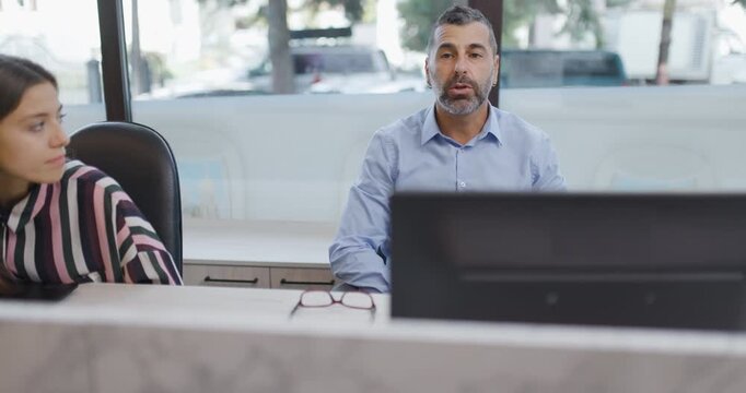 Travel Agent Assisting Clients in a Bright Office. Discussing and Planning Their Dream Vacation Getaway.