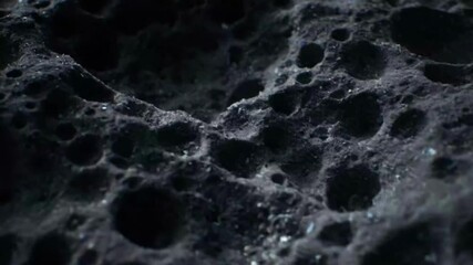 Dramatic asteroid surface detailed close up with motion and glistening light