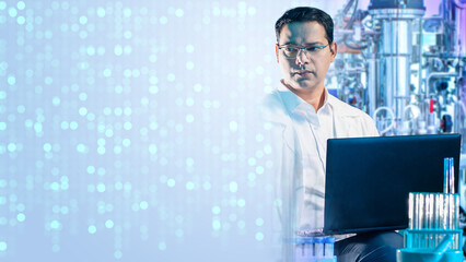 Biotechnology researcher analyzes data on laptop in laboratory with bioreactors, focusing on...