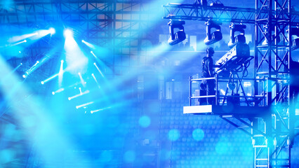 Cameraman operates professional broadcast camera at concert stage with bright lights, ensuring live...