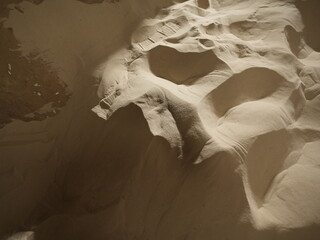 Aerial view of sand dunes with soft shadows and natural abstract patterns formed by wind
