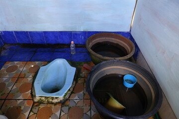 Low Angle of Squat Toilet and Water Containers