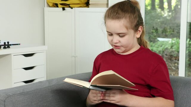 Child reading a book at home. Focused student learning quietly. Education and literacy development. Childhood curiosity and imagination. Peaceful study time indoors.