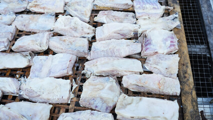 The process of smoking fish on the coast of Semarang Indonesia. Fresh fish is dried and smoked using a handmade stove. Traditional production