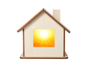 Toy house with a radiant sun shining through the window, isolated on black