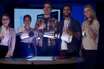 diverse robotics engineering team poses in an RD lab. The engineers, including an Indian woman,...