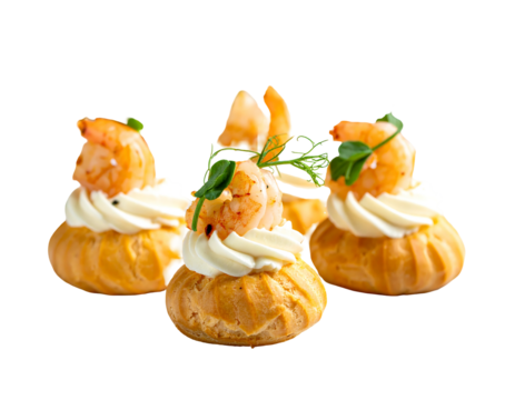 Three puff pastries topped with cream and grilled shrimp on a dark background, garnished with herbs