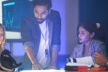 A startup team discusses future technology and innovation. They are analyzing data for a new AI robotics solution, planning for digital transformation and sustainable ESG goals.