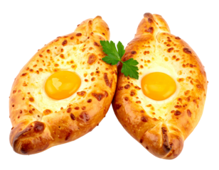 Two Adjarian khachapuri, boat-shaped cheese bread topped with an egg yolk, with green parsley garnish