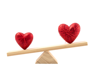 Two red yarn-wrapped hearts balanced on a wooden seesaw against a black background. Representing love, balance, and emotion