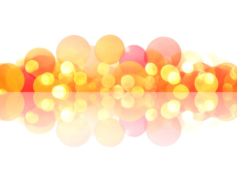 Warm abstract of overlapping orange and yellow circles with bokeh effect, reflected on a black background