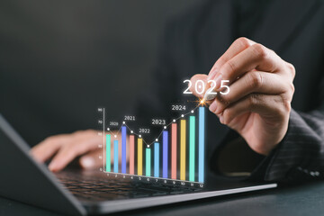 The 2025 New Year business goals concept. Businesswoman analysis graph of trend market growth in 2025 and plans business growth and profit increases. Financial data for long-term investments