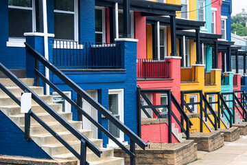 Row of colorful colonial apartment homes with stairs in Pittsburgh, Pennsylvania, USA.
