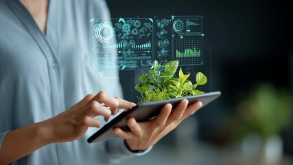 Businesswoman using tablet with plant and digital data analytics interface showing futuristic technology environmental monitoring growth sustainable agriculture innovation modern workspace - Powered by Adobe