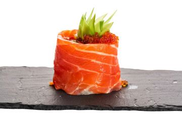 gourmet salmon sushi roll with roe on black slate.