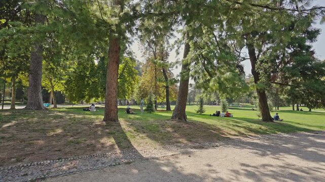 People Relaxing Under Trees, Parco Sempione, Milan, filmed on September 15, 2025.