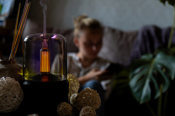 Indoors Decoration with modern lighted Air Humidification Aroma essential oil perfume fragrance. Scented home wellness wellbeing habit. Concept of feeling good spiritual health and being mindful