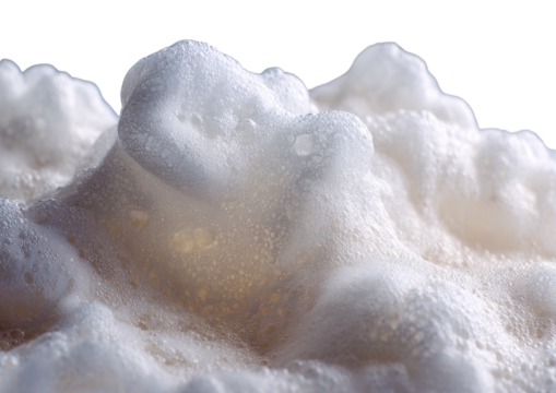 Heap of fluffy, pale foam against a dark background