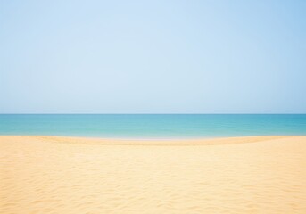 Fototapeta premium Minimalist view of a pristine golden sand beach meeting the turquoise ocean under a clear blue sky