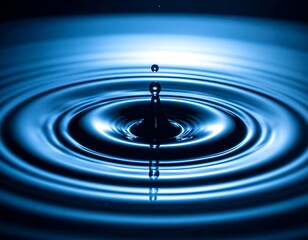 Droplet impact creates ripples in tranquil, reflective azure water