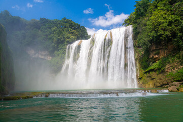 Close up on Huangguoshu Waterfall is a famous tourist attraction in Guizhou, China, summer picture, the waterfall is full of water