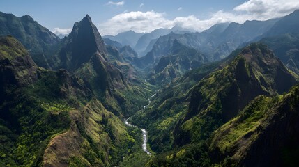 Naklejka premium Dramatic aerial view captures a deep, lush, verdant mountain valley carved by a winding river below