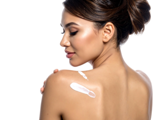 Woman applies cream. Isolated view of a woman with fair skin, a dark hair bun, and some cream on her shoulder