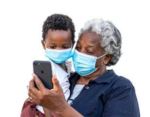 Woman holding child, both wearing masks and looking at a phone screen against a cutout, black background