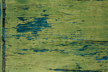 Rustic aged wooden wall texture with peeling green paint