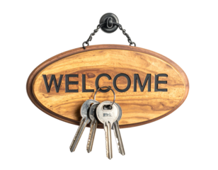 Wood sign displaying "WELCOME" is hung with keys; rustic charm evokes invitation and warmth against a black background