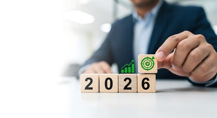 Businessman places a cube with a green leaf symbol on top of the year 2026 signifying growth and sustainability