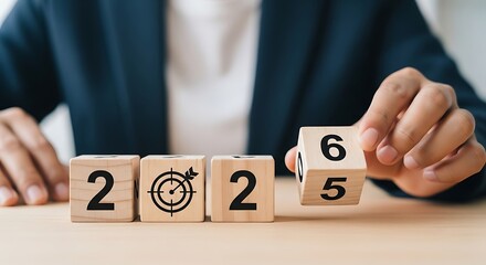 Business person s hands turning blocks from 2025 to 2026 symbolizing future planning and goal achievement