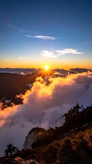 Dramatic sunrise over mountain peaks and fluffy cloud layers