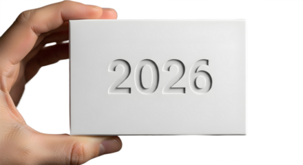 Minimalist hand holds white box with engraved “2026” — clean symbol for goals and futures.