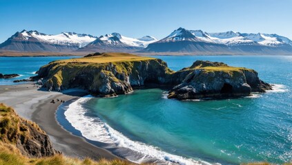 Naklejka premium Scenic view of a black sand beach with turquoise water and snowcapped mountains in the background on a sunny day in iceland, a beautiful travel destination
