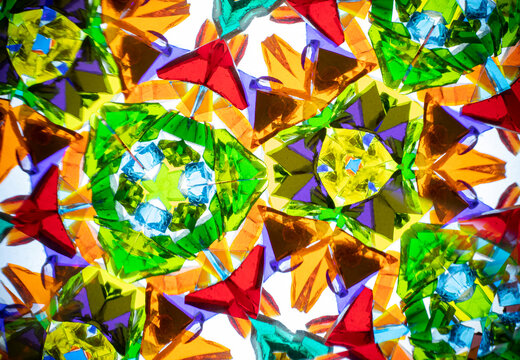 Stunning macro photograph of a natural kaleidoscope pattern, showcasing vibrant colored glass and light reflections.