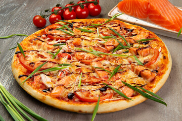 Pizza with salmon slices.