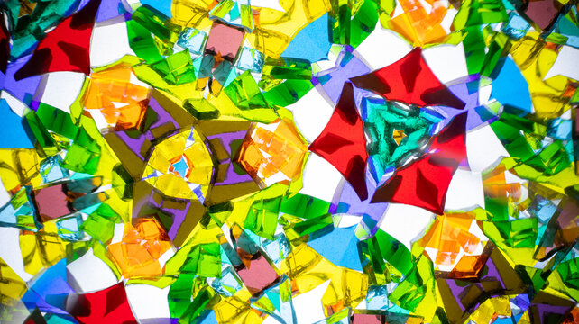 Stunning macro photograph of a natural kaleidoscope pattern, showcasing vibrant colored glass and light reflections.