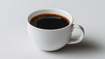 Fototapeta premium Plain white mug filled with dark roasted black coffee sits against a light background