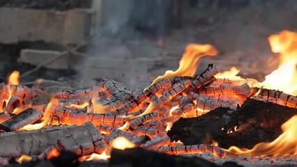 flames are burning in a pile of wood in a fire pit - Powered by Adobe
