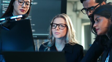 Diverse team of business professionals and developers collaborating on a digital project, focusing on code and data analysis in a dark, tech-savvy office. Cybersecurity and IT work. - Powered by Adobe