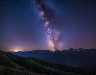 Night sky stars, Milky Way, blue purple sky in a starry night over mountains. Northern lights in the mountains.