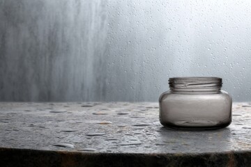 Jar on Japanese Bathroom Slab Surrounded by Water Droplets