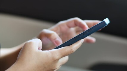 hand holding and using smartphone inside car for navigation gps, showing technology and communication while traveling, close-up