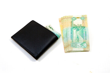 Leather wallet with currency notes closeup view on white background 