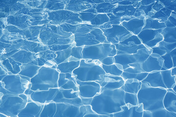 Blue Water Surface Texture in Swimming Pool with Bright Sun Reflection.