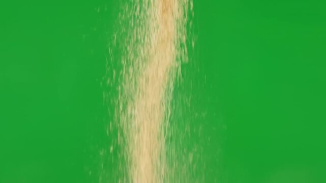 Slow motion fine sand particles falling against a smooth green screen visual effects, fine sand, isolated