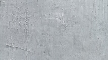 Abstract, heavily textured, bright white stucco or plaster wall surface with brush strokes and imperfections.